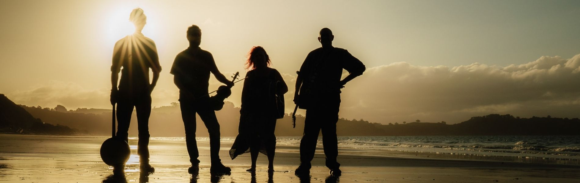 Gráinneog is Waiheke's finest folk band. The band is for hire for Waiheke weddings, and any other general entertainment around Waiheke and Auckland. In this photo they are standing with their instruments on their favourite Waiheke beach at sunset.